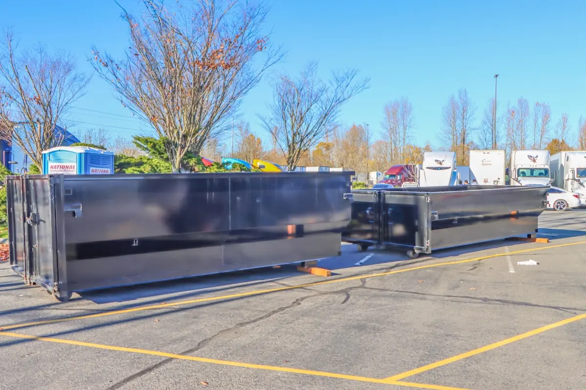 Professional dumpster rental service with roll-off container on residential driveway in Pelham